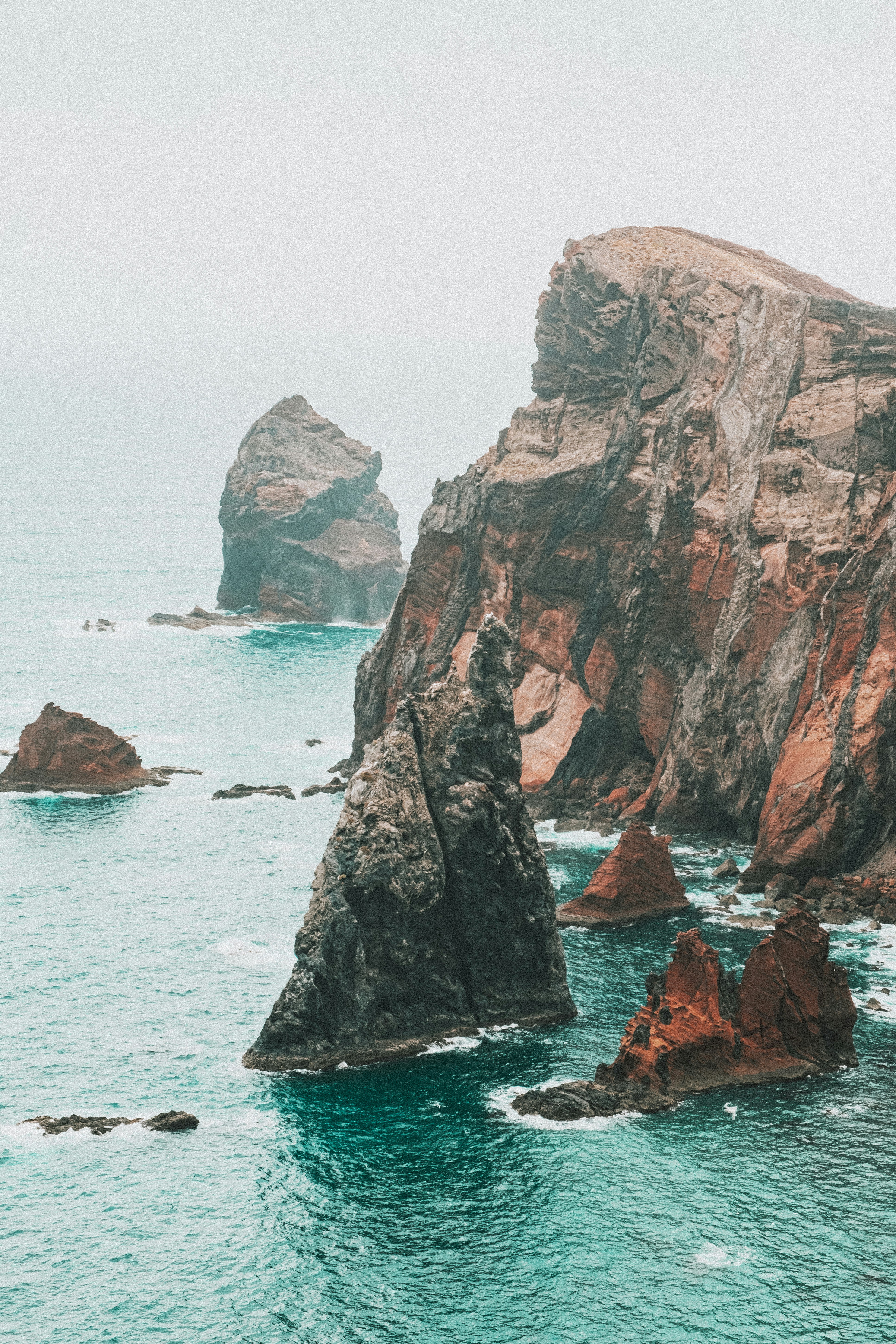 brown rock formation on sea during daytime